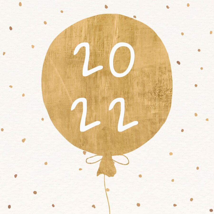 A gold balloon that says 2022 against a polka dot background to celebrate the New Year