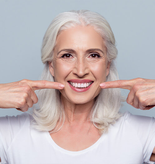 woman pointing to teeth