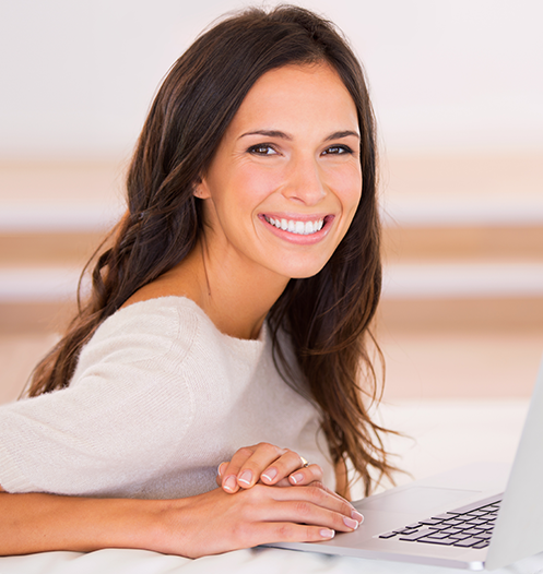 woman smiling with computer