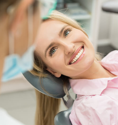 smiling woman sitting in a dental chair