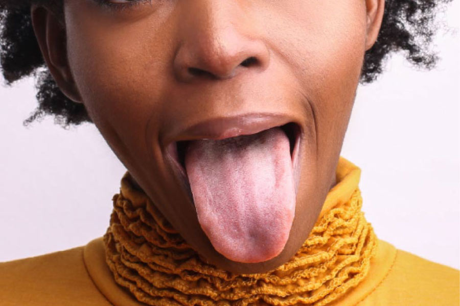 woman sticks out her tongue all the way
